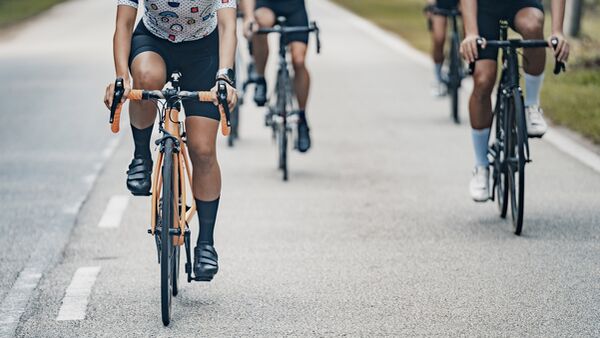 Asian Chinese female cyclist leading in cycling event rural scene