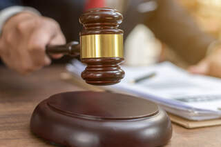 Close up lawyer businessman working or reading lawbook in office workplace for consultant lawyer concept.