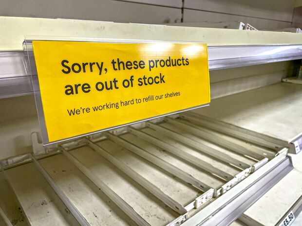 Empty Supermarket Shelves Apology Sign. Covid19 Coronavirus Pandemic affecting supply lines and deliveries due to lockdowns and closed borders. UK Pingdemic causes many essential food and retail staff to self isolate.