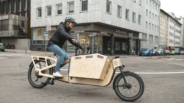 Frau in Stuttgart mit nachhaltigem RETHINK E-Lastenrad aus Holz