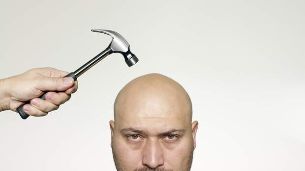 Hitting bald head with a hammer